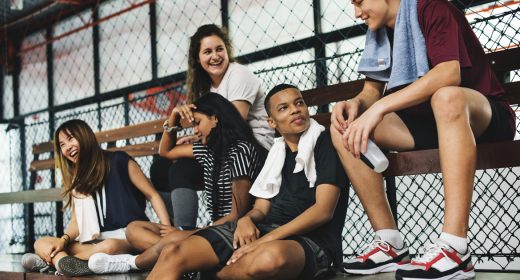 Group of young teenager friends sitting on a bench relaxing