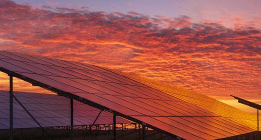 solar power plant on the background of dramatic, fiery sky at sunset